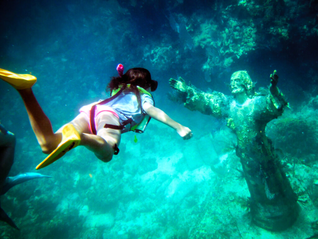 Scenic Highway US 1 in the Florida Keys. Girl Snorkeling to Christ of the Abyss Statue off Key Largo Florida Gulf of Mexico